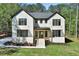Beautiful two-story brick home with a manicured lawn and lush trees in a serene neighborhood at 191 Darwish Dr, Mcdonough, GA 30252