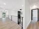 Open hallway featuring modern railing and chandelier at 191 Darwish Dr, Mcdonough, GA 30252
