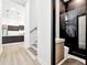 Hallway view of the modern kitchen and bathroom featuring stone shower at 191 Darwish Dr, Mcdonough, GA 30252