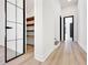 Bright hallway with a storage room and wood floors, leading to the rest of the open floorplan home at 191 Darwish Dr, Mcdonough, GA 30252