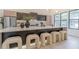 A modern kitchen features a large center island with barstool seating and stainless steel appliances at 191 Darwish Dr, Mcdonough, GA 30252