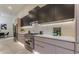 Modern kitchen featuring wood cabinets, stainless steel appliances, and a marble countertop at 191 Darwish Dr, Mcdonough, GA 30252