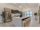 A bright, modern kitchen featuring a large center island with barstool seating and stainless steel appliances at 191 Darwish Dr, Mcdonough, GA 30252