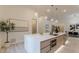 Modern kitchen featuring a large island with a marble countertop and stainless steel appliances and view of dining area at 191 Darwish Dr, Mcdonough, GA 30252