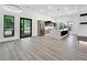 Open-concept kitchen features a large island, stainless steel appliances, and wood plank flooring at 191 Darwish Dr, Mcdonough, GA 30252