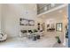 Bright, open-concept living room with stylish furniture, and a soaring two-story ceiling at 191 Darwish Dr, Mcdonough, GA 30252