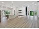 Bright, open-concept living room, modern kitchen, and a soaring two-story ceiling with outdoor views at 191 Darwish Dr, Mcdonough, GA 30252