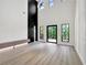 Bright, open-concept living room with modern finishes, and a soaring two-story ceiling with outdoor views at 191 Darwish Dr, Mcdonough, GA 30252