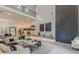 Bright, open-concept living room with modern finishes, stylish furniture, and a soaring two-story ceiling at 191 Darwish Dr, Mcdonough, GA 30252