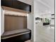 Mudroom with built-in seating, storage, and lighting at 191 Darwish Dr, Mcdonough, GA 30252