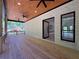 Spacious covered porch with recessed lighting, ceiling fans, and wood flooring perfect for outdoor entertaining at 191 Darwish Dr, Mcdonough, GA 30252