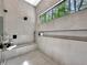 An elegant walk-in shower featuring a large window and built-in shower bench at 191 Darwish Dr, Mcdonough, GA 30252