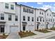 Attractive new townhome exteriors featuring individual garages and manicured landscaping at 3145 Washburn Sw St, Atlanta, GA 30354