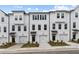 New townhome exterior with white siding, a single car garage, and professionally landscaped front yards at 3145 Washburn Sw St, Atlanta, GA 30354