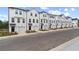 Wide shot of new construction townhomes with garages, driveways, and manicured lawns at 3149 Washburn Sw St, Atlanta, GA 30354