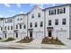 New townhomes with white siding, black shutters and doors, and manicured lawns at 3149 Washburn Sw St, Atlanta, GA 30354
