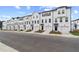 Long shot of new construction townhomes with white exteriors, dark trim, and single car garages at 3149 Washburn Sw St, Atlanta, GA 30354
