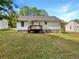 View of the rear of the home with a cozy wooden deck and sprawling backyard at 45 Carroll St, Temple, GA 30179