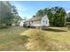 View of backyard of home with an expansive lawn and mature trees, perfect for outdoor enjoyment at 45 Carroll St, Temple, GA 30179