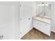 A clean, well-lit bathroom with a white vanity, countertop, and tile flooring at 45 Carroll St, Temple, GA 30179