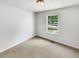 Clean and bright bedroom with neutral carpet and a large window offering natural light at 45 Carroll St, Temple, GA 30179