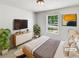 Cozy bedroom featuring a comfortable bed, modern decor, and a large window with natural light at 45 Carroll St, Temple, GA 30179