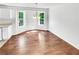 Bright dining area with large windows, stylish lighting, and hardwood floors at 45 Carroll St, Temple, GA 30179