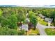 An aerial view of the property showcases the backyard, including the pool, gardens, and surrounding trees at 725 Crab Orchard Ct, Roswell, GA 30076