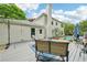Deck with outdoor seating overlooking a fenced backyard with trees and a pool, ideal for outdoor enjoyment at 725 Crab Orchard Ct, Roswell, GA 30076