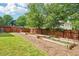 The spacious backyard features a garden and a well-maintained lawn surrounded by a wooden fence at 725 Crab Orchard Ct, Roswell, GA 30076