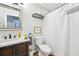 Bright bathroom featuring a single sink vanity, framed mirror, and a shower with white curtain at 725 Crab Orchard Ct, Roswell, GA 30076