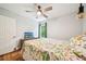 Bright bedroom with a ceiling fan, closet, wood floors, and a window with green outdoor view at 725 Crab Orchard Ct, Roswell, GA 30076