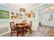 Charming dining area featuring a round wooden table, cross back chairs, and decorative wall art in a cozy home at 725 Crab Orchard Ct, Roswell, GA 30076