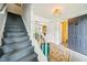 Entryway featuring a staircase, neutral colors, and doorway to a living space at 725 Crab Orchard Ct, Roswell, GA 30076