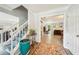 Welcoming foyer with staircase and doorway to a living room with a fireplace at 725 Crab Orchard Ct, Roswell, GA 30076