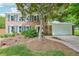 Charming two-story brick home featuring blue shutters and a well-manicured front yard with a two car garage at 725 Crab Orchard Ct, Roswell, GA 30076
