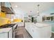 Modern kitchen with a large island, white cabinets, stainless steel appliances, and yellow subway tile backsplash at 725 Crab Orchard Ct, Roswell, GA 30076