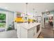 Stylish kitchen featuring a large island, white cabinets, and stainless steel appliances adjacent to the dining area at 725 Crab Orchard Ct, Roswell, GA 30076