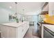 Spacious kitchen featuring a large island, stainless steel appliances, and access to a light-filled dining area at 725 Crab Orchard Ct, Roswell, GA 30076