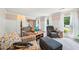 Inviting living room showcasing plush seating, large windows, and stylish decor in a home with white wall paneling at 725 Crab Orchard Ct, Roswell, GA 30076