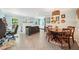 Spacious living room open to dining with light-filled windows and a cozy fireplace at 725 Crab Orchard Ct, Roswell, GA 30076