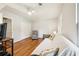 Inviting living room with hardwood floors, a recliner, futon, and natural light from a window at 725 Crab Orchard Ct, Roswell, GA 30076
