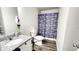 Bathroom with a single sink, granite countertop and a dinosaur themed shower curtain over the bath tub at 11 Plymouth Ct, Kingston, GA 30145