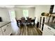 Cozy dining area featuring a wooden table, comfortable seating, and ample natural light from the window at 11 Plymouth Ct, Kingston, GA 30145