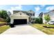 Charming two-story home with a black garage door, neutral siding, and neatly landscaped front yard at 11 Plymouth Ct, Kingston, GA 30145