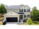 Charming two-story home with a black garage door, neutral siding, and neatly landscaped front yard at 11 Plymouth Ct, Kingston, GA 30145