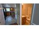 Cozy bathroom with wooden cabinets and sink next to a kitchen with black appliances at 1395 Kala Dr, Lithonia, GA 30058