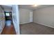 Neutral colored bedroom with new carpet and view into kitchen and hallway at 1395 Kala Dr, Lithonia, GA 30058