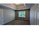 Bedroom with tray ceiling, plush carpeting, and natural light creating a relaxing retreat at 1395 Kala Dr, Lithonia, GA 30058