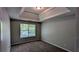 Bedroom with tray ceiling and plush carpeting creates a comfortable, inviting atmosphere at 1395 Kala Dr, Lithonia, GA 30058